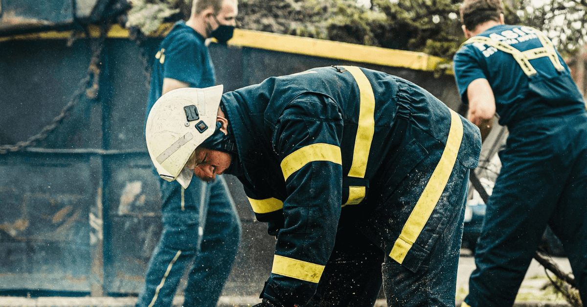 Arborist inspecting a leaning tree for safety and removal in New Jersey