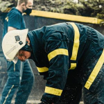 Arborist inspecting a leaning tree for safety and removal in New Jersey